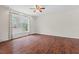 Expansive living space featuring hardwood flooring, neutral walls, and a large window at 7 Harrigan Ct, Durham, NC 27705
