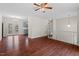 Hardwood floors throughout a large living area next to dining area and staircase at 7 Harrigan Ct, Durham, NC 27705