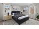 Staged primary bedroom with lamps on nightstands, bed with linens and artwork at 7 Harrigan Ct, Durham, NC 27705