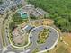 Aerial view of community park featuring a playground, pool, and tennis courts at 705 Vine Pkwy, Pittsboro, NC 27312