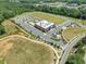 Aerial view of community recreation center with parking, playground, and athletic field at 705 Vine Pkwy, Pittsboro, NC 27312