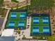 Aerial view of the community pickleball courts amid lush trees and landscaping at 705 Vine Pkwy, Pittsboro, NC 27312