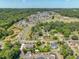 Aerial view of the community featuring numerous homes nestled among lush trees at 705 Vine Pkwy, Pittsboro, NC 27312