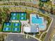 Aerial view of the community pool and pickleball courts with surrounding neighborhood at 705 Vine Pkwy, Pittsboro, NC 27312