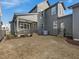 View of gray home's backyard featuring a covered patio and convenient back door at 705 Vine Pkwy, Pittsboro, NC 27312