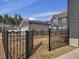 View of gray home's backyard featuring a fenced-in area with dry grass and blue sky at 705 Vine Pkwy, Pittsboro, NC 27312