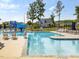 Community pool with a slide, lounge chairs, and beautiful landscaping at 705 Vine Pkwy, Pittsboro, NC 27312