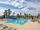 Community pool view, with a slide, lounge seating, umbrellas and neighborhood homes in background at 705 Vine Pkwy, Pittsboro, NC 27312