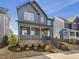 Beautiful two-story home featuring a covered porch, stylish exterior, and professionally landscaped front yard at 705 Vine Pkwy, Pittsboro, NC 27312