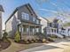 Two-story home with a cozy front porch, manicured lawn, and contemporary design elements at 705 Vine Pkwy, Pittsboro, NC 27312