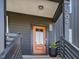 Close-up of the stylish front door with modern hardware, decorative pot, and house number at 705 Vine Pkwy, Pittsboro, NC 27312