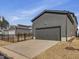 Detached two-car garage with driveway and black metal fencing, in a landscaped yard at 705 Vine Pkwy, Pittsboro, NC 27312