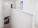 Bright hallway featuring a white painted railing and a view of the living room below at 705 Vine Pkwy, Pittsboro, NC 27312