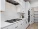 Close up of the kitchen stove, oven, and microwave against a white subway tile backsplash at 705 Vine Pkwy, Pittsboro, NC 27312