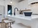 Close up of kitchen island with seating, sleek faucet, and modern black accents at 705 Vine Pkwy, Pittsboro, NC 27312