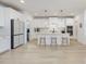 Bright kitchen boasts white cabinetry, center island with seating and pendant lighting at 705 Vine Pkwy, Pittsboro, NC 27312