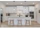 Bright kitchen boasts white cabinetry, center island with seating and pendant lighting at 705 Vine Pkwy, Pittsboro, NC 27312