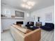 Cozy living room featuring a fireplace, mounted tv, modern lighting, and comfortable seating at 705 Vine Pkwy, Pittsboro, NC 27312