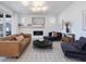 Comfortable living room with fireplace, mounted tv, modern lighting, and open floor plan at 705 Vine Pkwy, Pittsboro, NC 27312