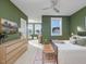 Spacious main bedroom with a bench seat, a ceiling fan, and large windows for ample natural light at 705 Vine Pkwy, Pittsboro, NC 27312