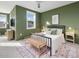 Green bedroom with a ceiling fan, a cozy rug, an airy feel, and a comfortable bed with stylish accents at 705 Vine Pkwy, Pittsboro, NC 27312