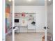 Bright office featuring a wall mounted shelving unit with desk, chair, and colorful accent wall at 705 Vine Pkwy, Pittsboro, NC 27312