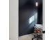 Small home office with a black wall, desk, chair, and natural lighting from a window at 705 Vine Pkwy, Pittsboro, NC 27312