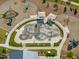 Aerial view of splash pad surrounded by benches and playground equipment at 705 Vine Pkwy, Pittsboro, NC 27312