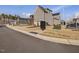 Street view of gray home featuring manicured landscaping and community mailbox at 705 Vine Pkwy, Pittsboro, NC 27312