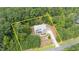 Aerial view of a charming home surrounded by lush greenery, showcasing its serene location at 766 Horizon Dr, Pittsboro, NC 27312