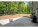 Backyard featuring a patio and a fire pit with a wooded view at 766 Horizon Dr, Pittsboro, NC 27312