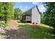 View of the house with backyard, including a screened porch and a spacious green area at 766 Horizon Dr, Pittsboro, NC 27312