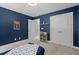 Bedroom featuring blue walls, carpet and white closets providing ample storage at 766 Horizon Dr, Pittsboro, NC 27312