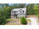 Front view of a two-story home with a stone accent wall and a well-manicured lawn at 766 Horizon Dr, Pittsboro, NC 27312