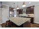 Spacious kitchen with a large granite island and modern stainless steel appliances at 766 Horizon Dr, Pittsboro, NC 27312