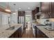 Modern kitchen featuring dark cabinets, granite countertops and stainless appliances at 766 Horizon Dr, Pittsboro, NC 27312