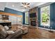 Open living room boasts a stone fireplace, hardwood floors, and a seamless flow to the kitchen at 766 Horizon Dr, Pittsboro, NC 27312