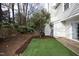 A tidy and well-kept backyard featuring a trimmed lawn and mulch for a relaxing outdoor retreat at 7736 Falcon Rest Cir, Raleigh, NC 27615