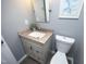 Bathroom featuring granite countertop, gray walls and modern fixtures at 7736 Falcon Rest Cir, Raleigh, NC 27615
