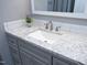 Close-up of bathroom vanity featuring a granite countertop, updated fixtures, and ample cabinet space at 7736 Falcon Rest Cir, Raleigh, NC 27615