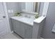Stylish bathroom vanity with marble countertop, modern faucet, and ample storage in a calming grey color palette at 7736 Falcon Rest Cir, Raleigh, NC 27615