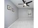 Neutral bedroom with carpet, modern fan, and a window that brings natural light to the space at 7736 Falcon Rest Cir, Raleigh, NC 27615