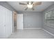 Bright bedroom featuring plush carpet, a ceiling fan, and dual closets for plenty of storage at 7736 Falcon Rest Cir, Raleigh, NC 27615