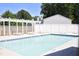 Community pool with surrounding lounge chairs and white pergola with lattice at 7736 Falcon Rest Cir, Raleigh, NC 27615