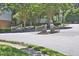 Community entrance gate with white lattice and meticulously maintained landscaping at 7736 Falcon Rest Cir, Raleigh, NC 27615