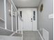 Bright foyer with tile floors, a white front door and staircase at 7736 Falcon Rest Cir, Raleigh, NC 27615