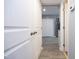 Hallway leading to the kitchen with modern door hardware at 7736 Falcon Rest Cir, Raleigh, NC 27615