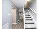 Hallway with carpeted stairs leading to a spacious living area and light gray walls at 7736 Falcon Rest Cir, Raleigh, NC 27615