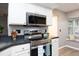 Kitchen featuring stainless steel oven, built-in microwave, and bay window at 7736 Falcon Rest Cir, Raleigh, NC 27615