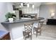 Elegant kitchen featuring bar seating, pendant lighting, and stainless steel appliances at 7736 Falcon Rest Cir, Raleigh, NC 27615